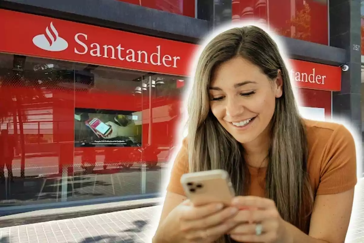 Una dona somrient usant el telèfon mòbil davant d'una sucursal del banc Santander.