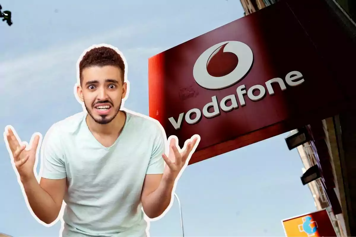 Un home amb expressió de frustració davant d'un cartell de Vodafone.