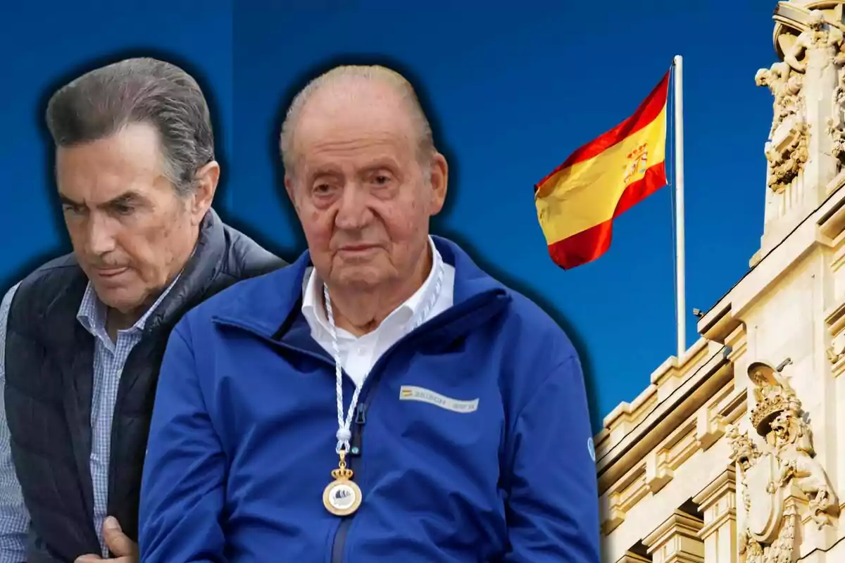 Pedro Campos i Joan Carles I en primer pla amb expressió seriosa i al fons una bandera d’Espanya onejant sobre un edifici històric