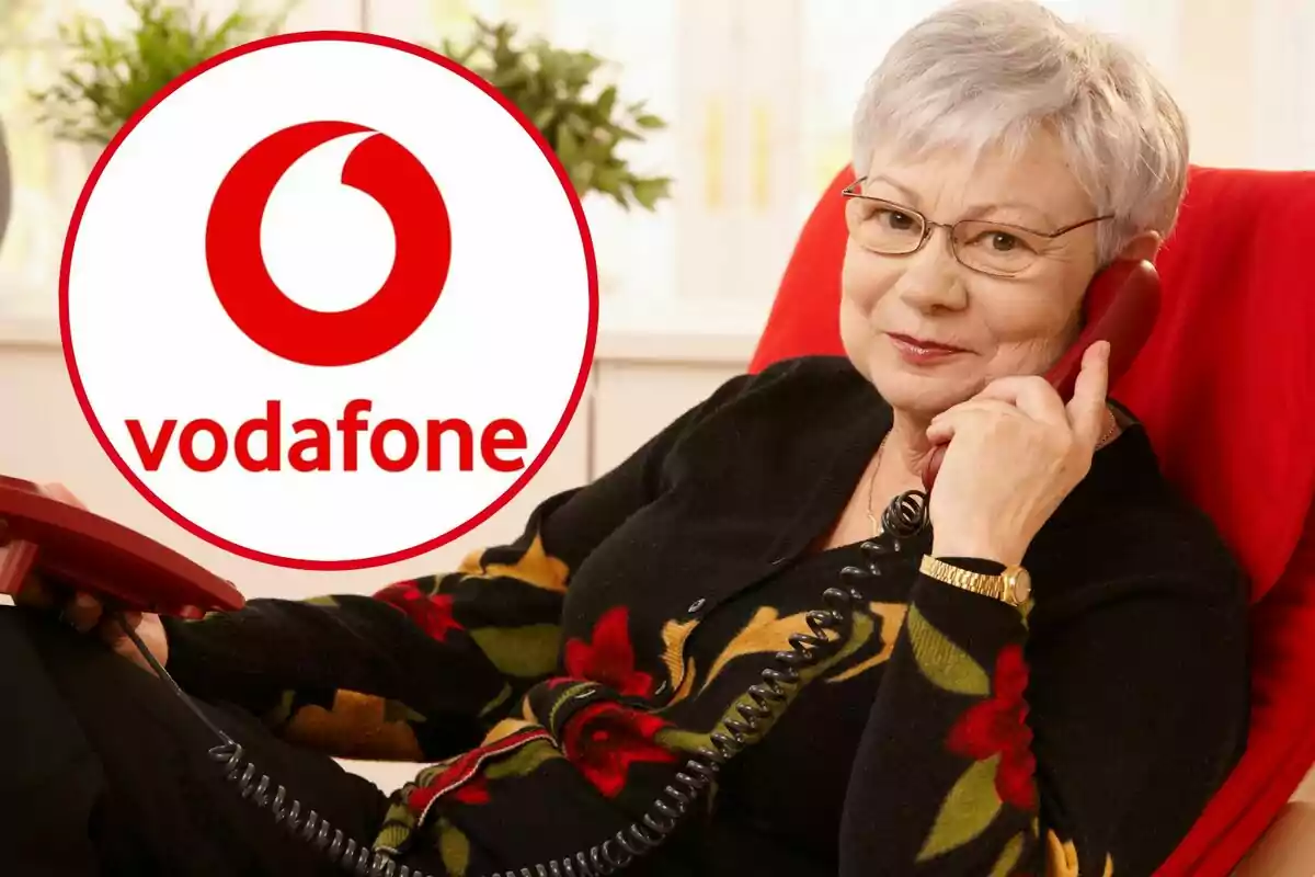 Una dona parla per telèfon fix, i al cercle, el logotip de Vodafone