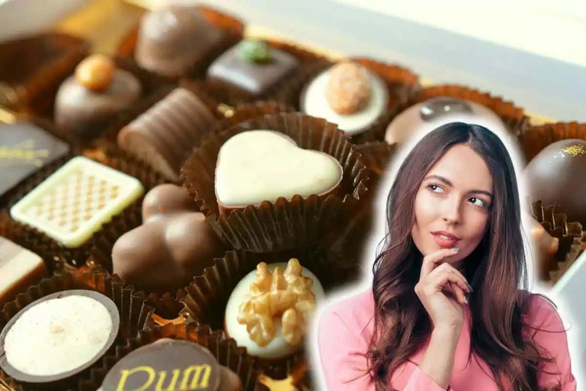 Una dona pensativa davant d'una caixa de bombons variats.