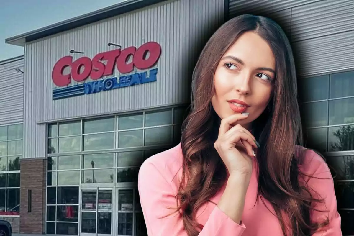 A thoughtful woman with one hand on her chin in front of a Costco building.