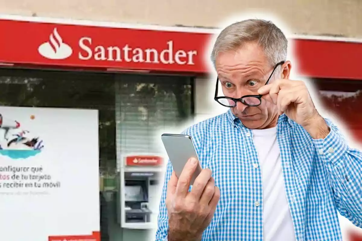 Home sorprès mirant el telèfon davant d'una sucursal del Banco Santander.