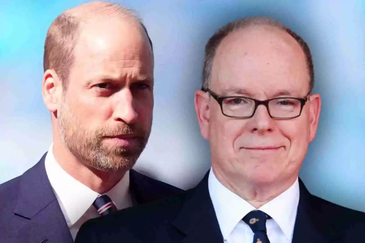 Albert of Monaco and Prince William in suits pose together in front of a blurred blue background.