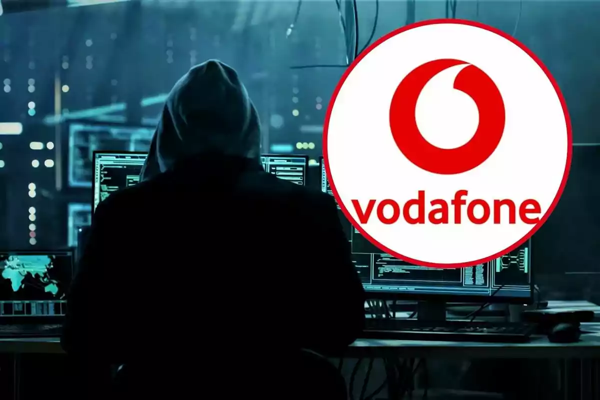 Una persona amb caputxa davant de múltiples pantalles dordinador en un entorn fosc amb el logotip de Vodafone superposat.