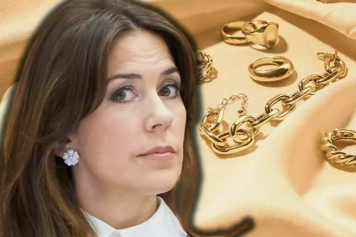 Mary of Denmark with white flower earrings appears in the foreground while in the background golden jewelry is seen on beige fabric.