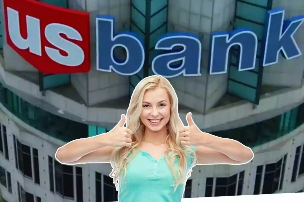A smiling woman with thumbs up in front of a building with a bank logo.