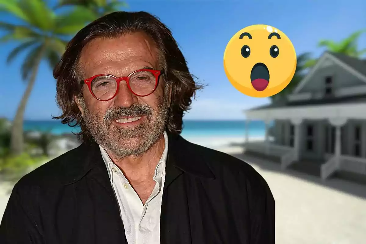 Un home amb ulleres vermelles i barba somriu davant d'un fons de platja amb una casa i una palmera, acompanyat d'un emoji sorprès.