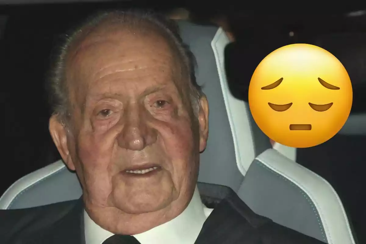 Joan Carles I assegut en un automòbil amb un emoji de cara pensativa superposat.