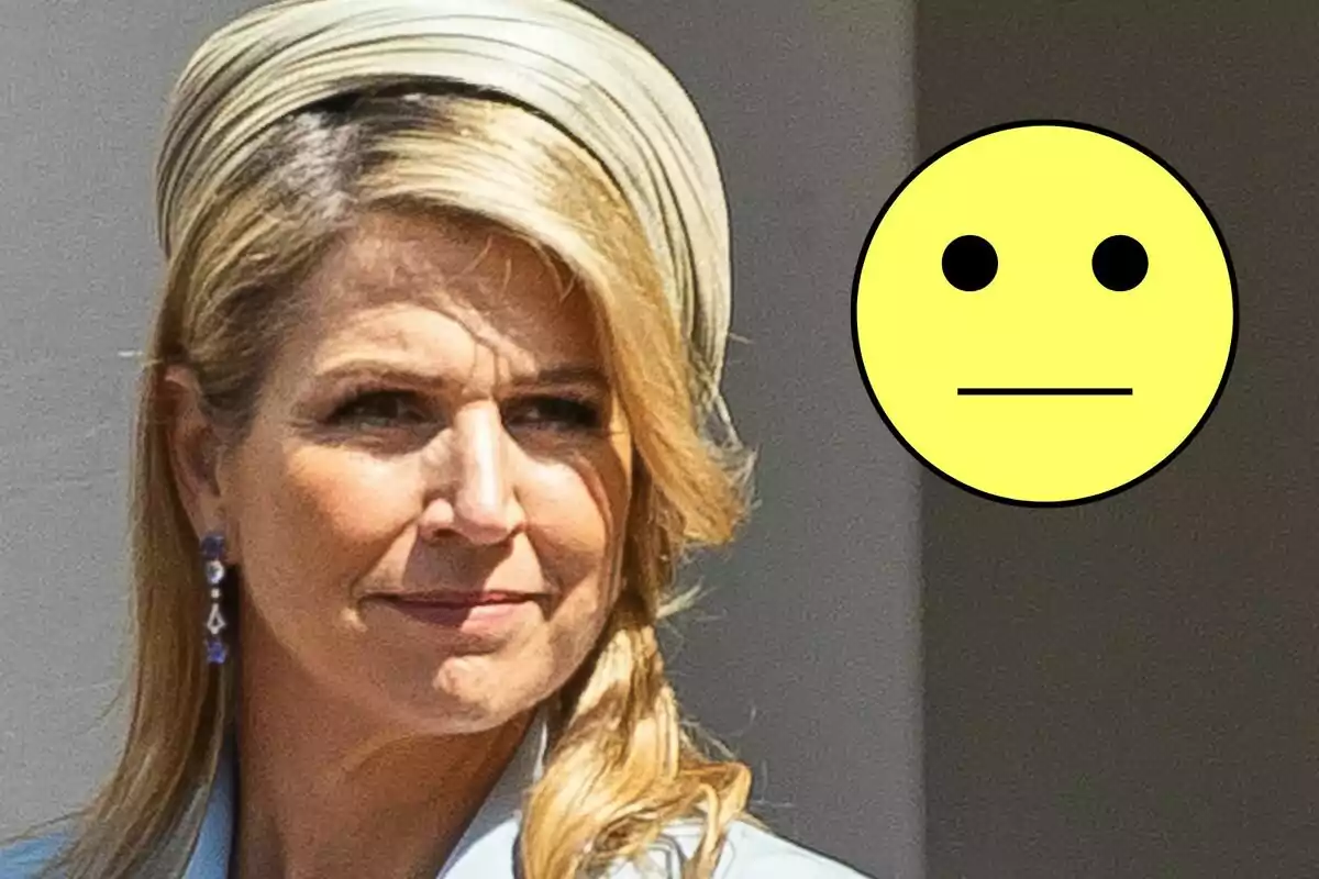 Máxima of the Netherlands with a light hat and a yellow emoji with a neutral expression.