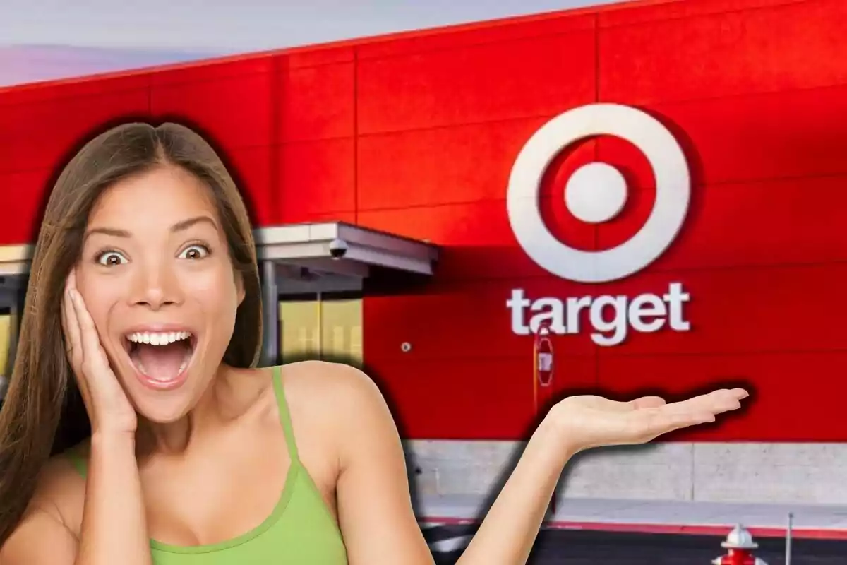 A smiling woman with an expression of surprise and excitement, with one hand raised, in front of a red building with the Target logo.