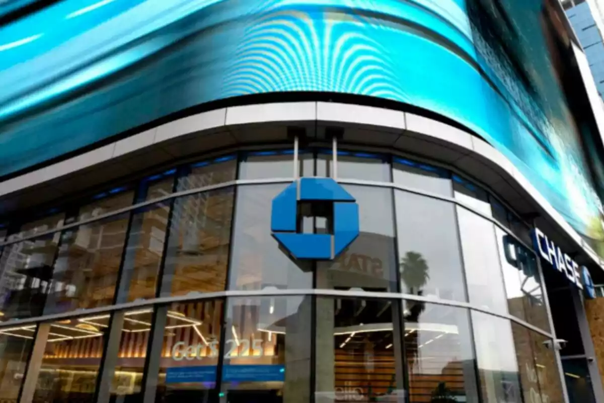 Facade of a bank with a blue logo and a large digital sign on top. Facade of a bank with a blue logo and a large digital sign on top.