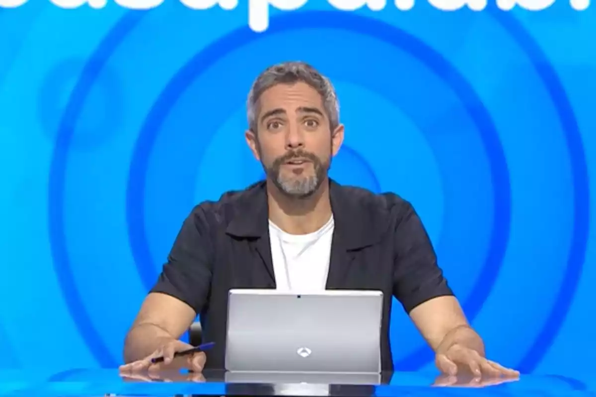 Roberto Leal assegut davant d’un portàtil en un plató de televisió amb fons blau. Captura de ‘Pasapalabra’. Roberto Leal assegut davant d’un portàtil en un plató de televisió amb fons blau. Captura de ‘Pasapalabra’.