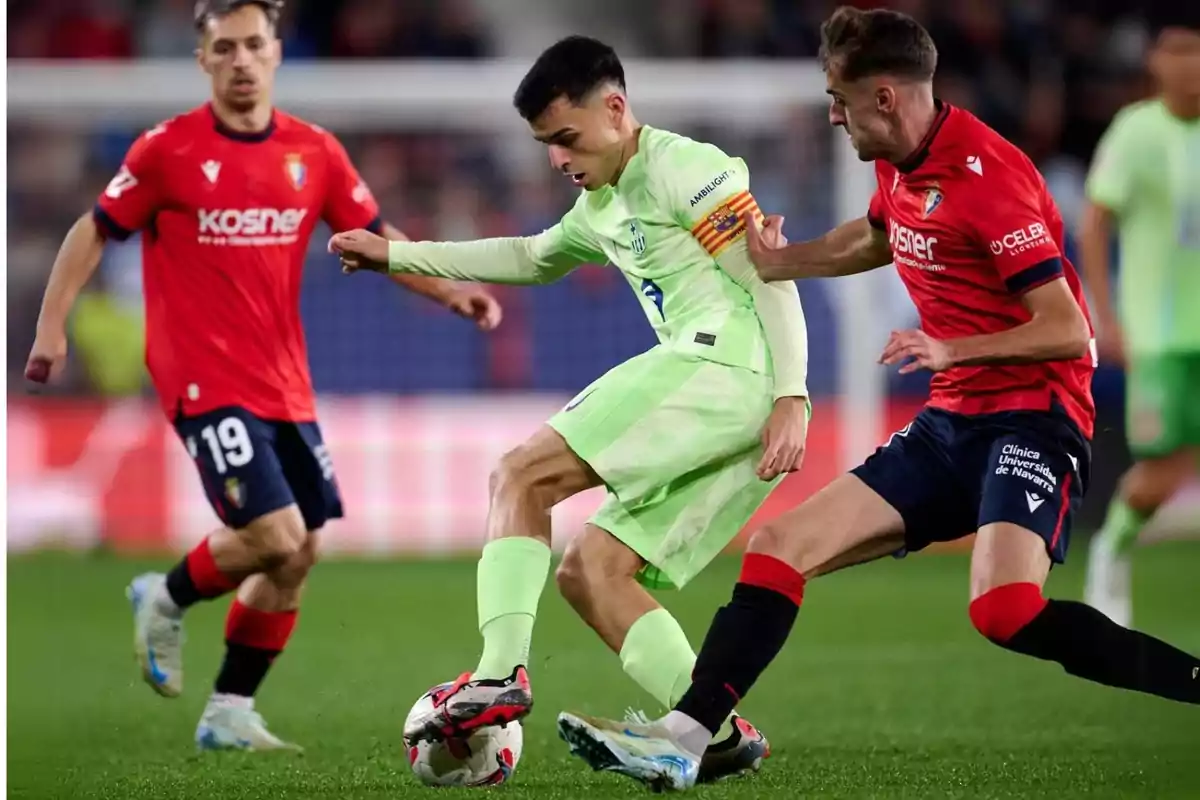 Soccer players compete for the ball during a match. Soccer players compete for the ball during a match.