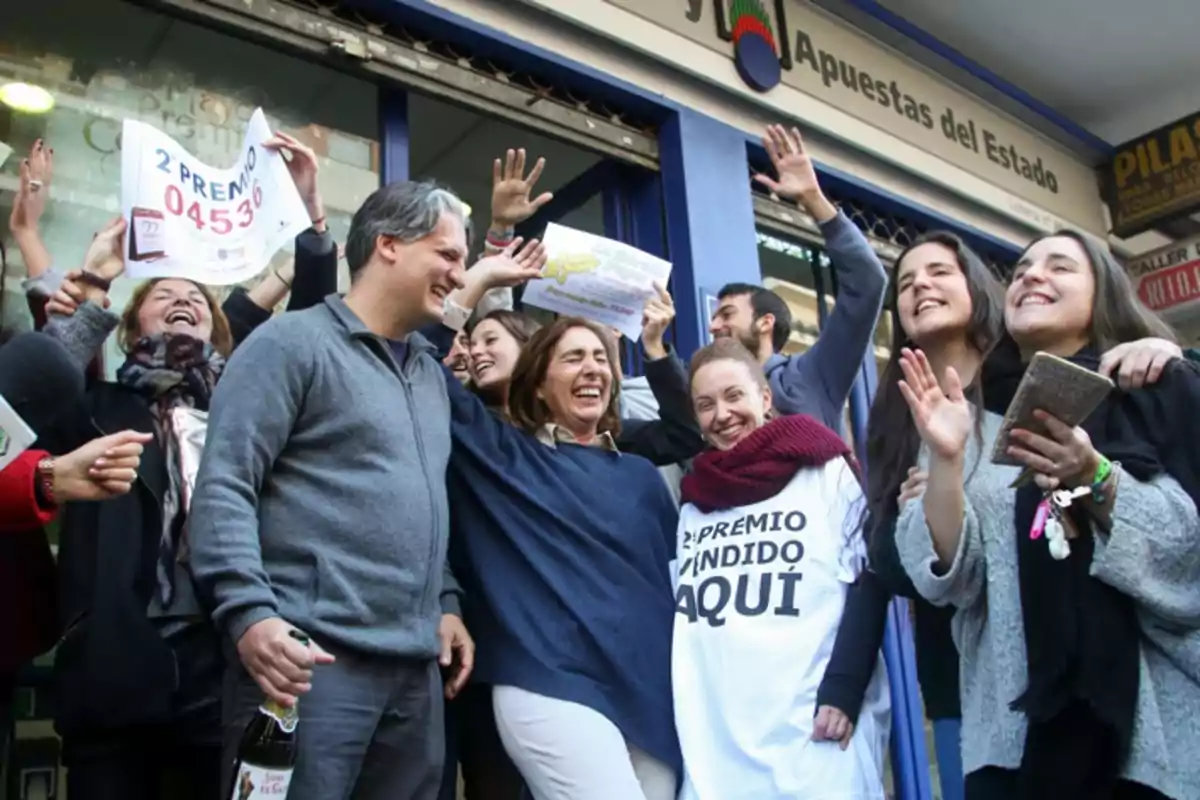 A group of people celebrate joyfully in front of the lottery office, holding up a sign indicating that they have won the second prize.