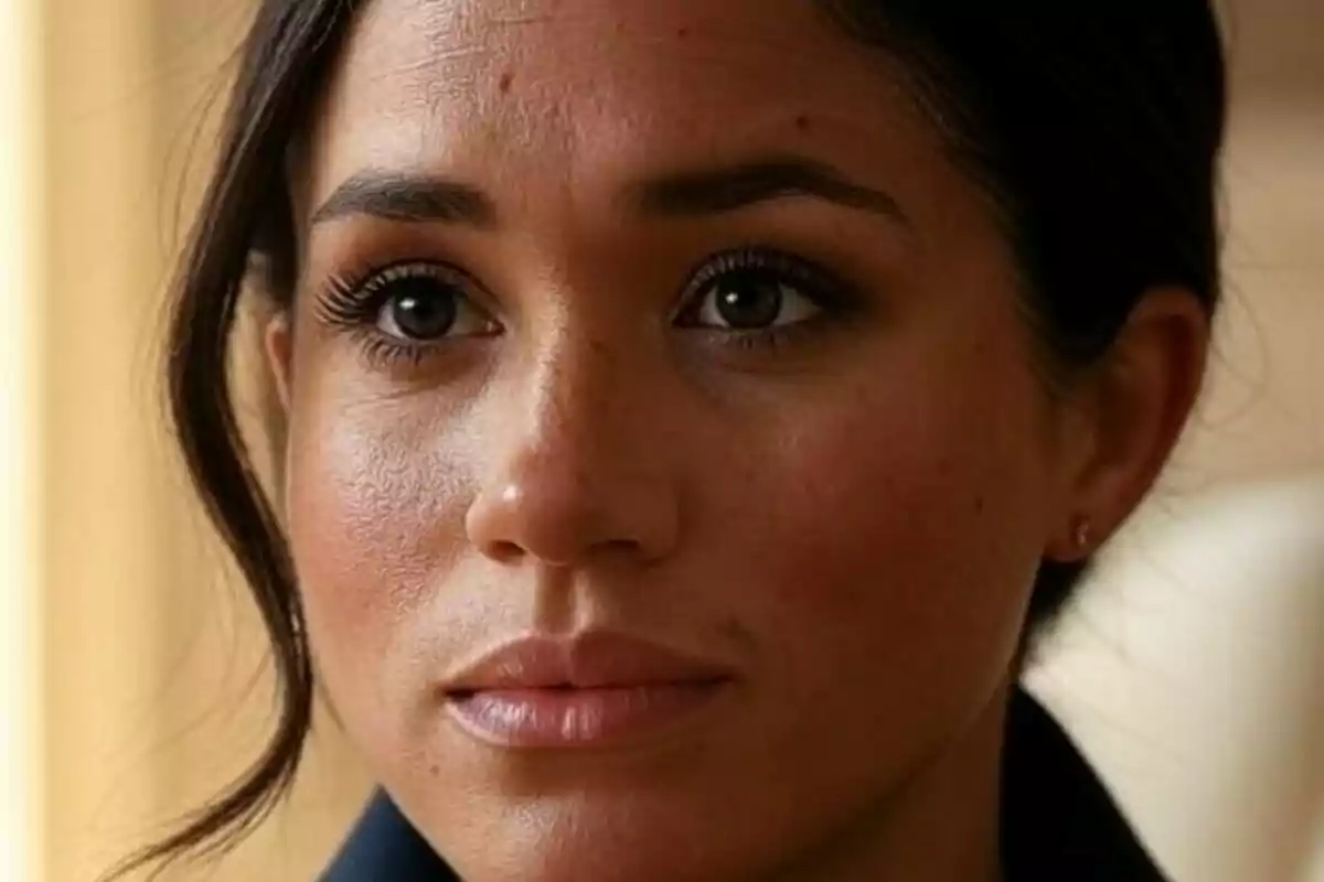 Close-up of Meghan Markle with a serious expression and dark hair pulled back Close-up of Meghan Markle with a serious expression and dark hair pulled back