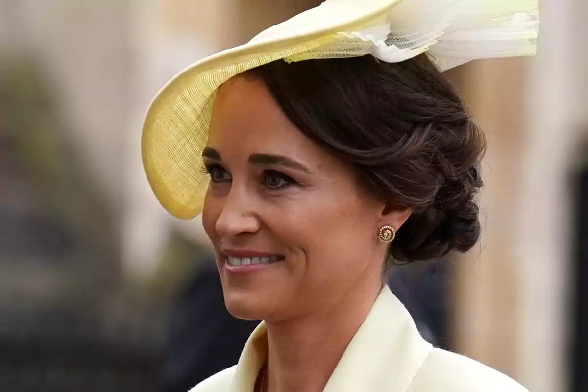Pippa Middleton in an elegant yellow hat and an updo hairstyle smiles. Pippa Middleton in an elegant yellow hat and an updo hairstyle smiles.