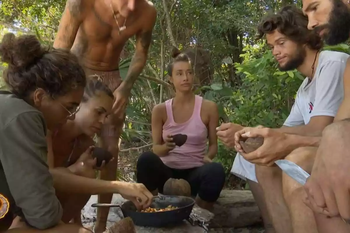 Captura de Alma Bollo, Adara Molinero, Jonan Wiergo, Raquel Arias, Bosco Blach Martínez-Bordiú i Diego Pérez a la platja de 'Supervivientes 2023' menjant