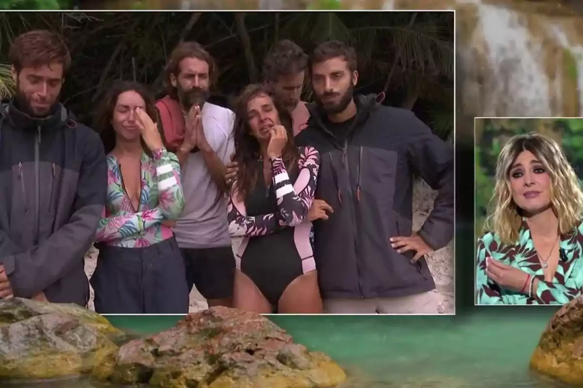 Un grup de persones en una platja sembla emocionat mentre Sandra Barneda en un requadre petit observa des d'un estudi. Captura de 'Supervivientes'. Un grup de persones en una platja sembla emocionat mentre Sandra Barneda en un requadre petit observa des d'un estudi. Captura de 'Supervivientes'.