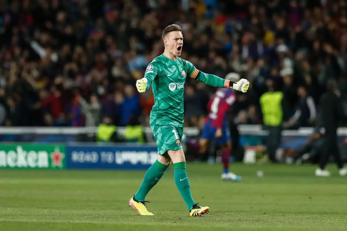 A soccer goalkeeper celebrating on the field with his arms outstretched and the crowd in the background. A soccer goalkeeper celebrating on the field with his arms outstretched and the crowd in the background.