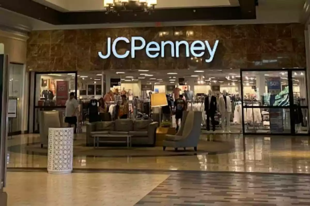 Entrance of a JCPenney store in a mall with a seating area in front and mannequins visible inside. Entrance of a JCPenney store in a mall with a seating area in front and mannequins visible inside.