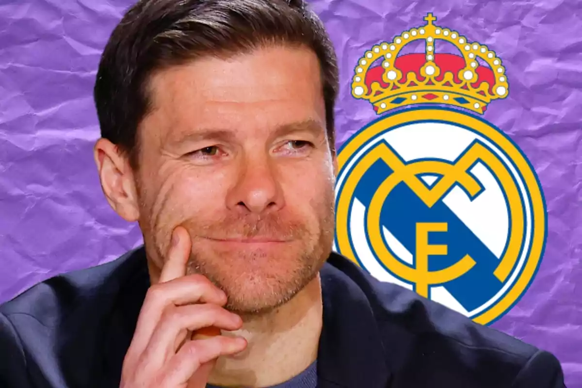 Un hombre pensativo con barba ligera frente a un fondo morado con el escudo del Real Madrid. Un hombre pensativo con barba ligera frente a un fondo morado con el escudo del Real Madrid.