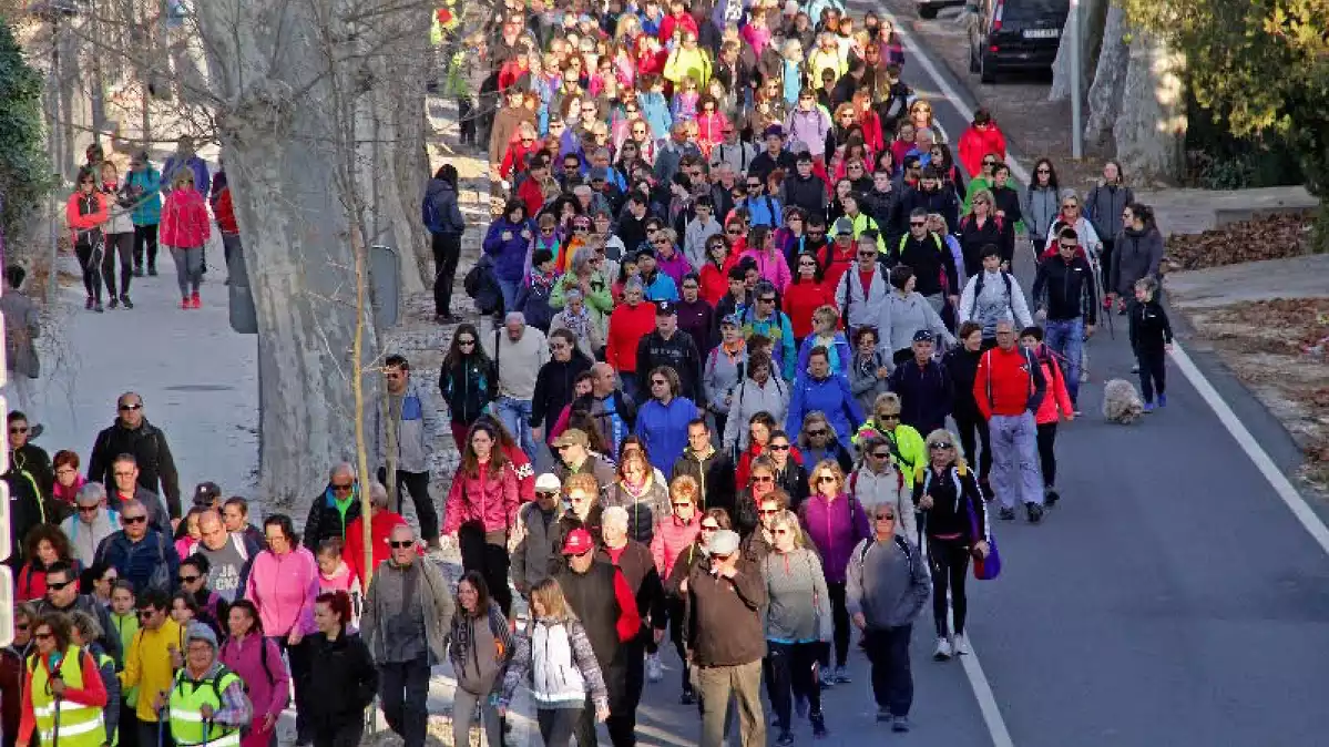 Centenars de persones en l'onzena caminada popular de Valls en un tram de la carretera.