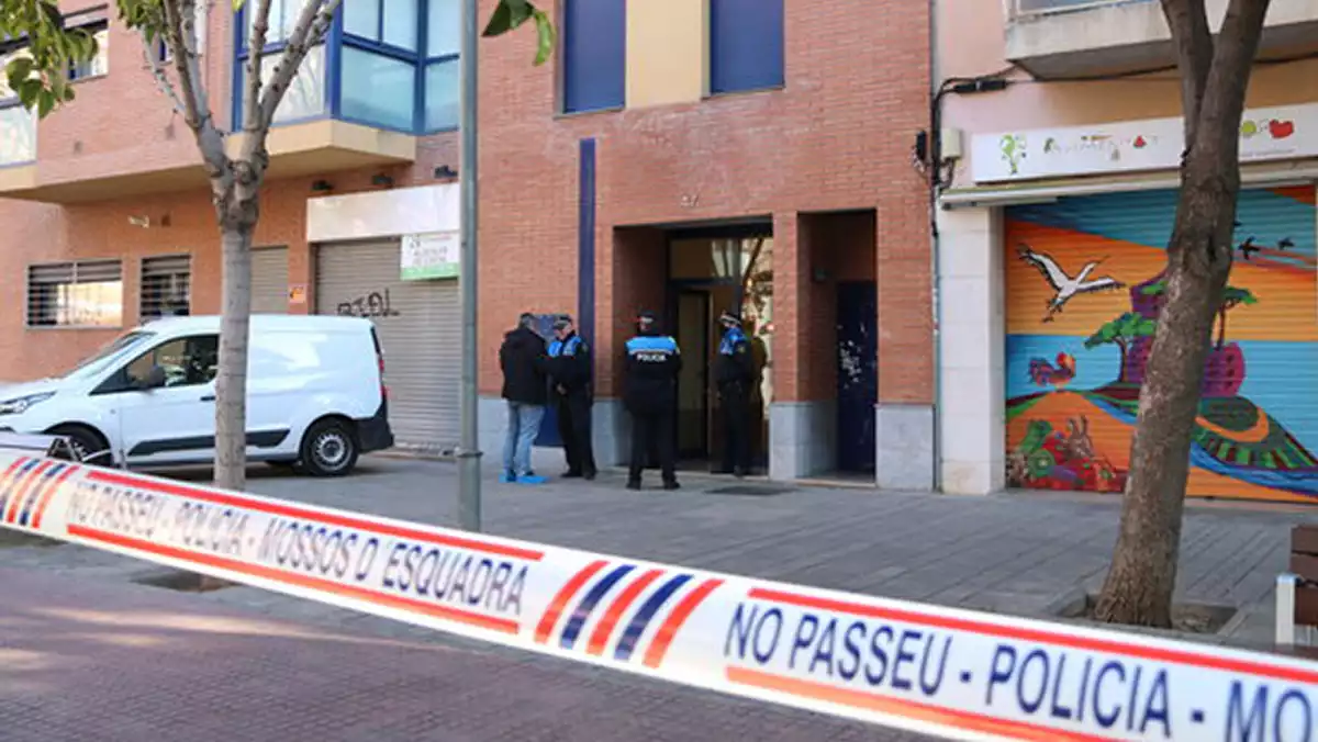 Cordó policial i Mossos d'Esquadra a la porta de l'edifici d'Esplugues on hi ha el domicili on un home ha estat detingut acusat de matar la seva dona i la filla de 3 anys el 6 de gener del 2020.