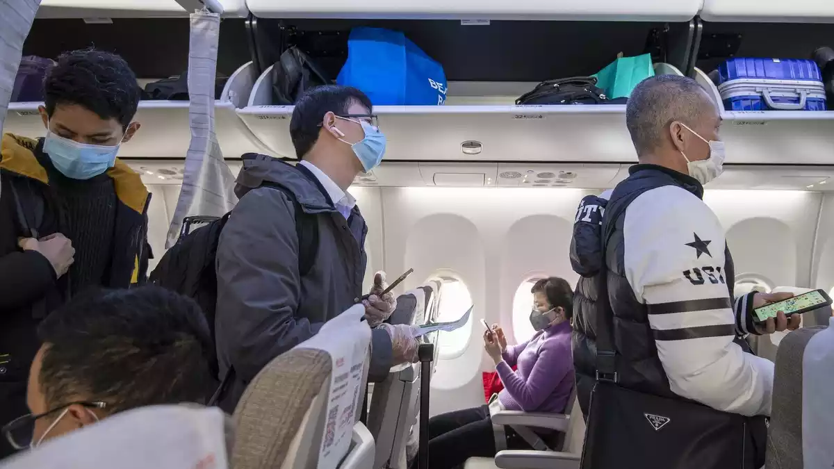 Viatgers xinesos amb mascaretes en un vol a la Xina el 8 de febrer de 2020