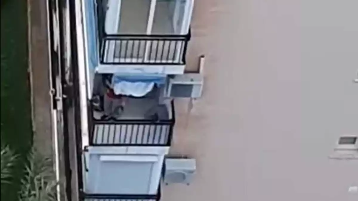 Un home disparant des del balcó durant els aplaudiments de les huit en Finestrat