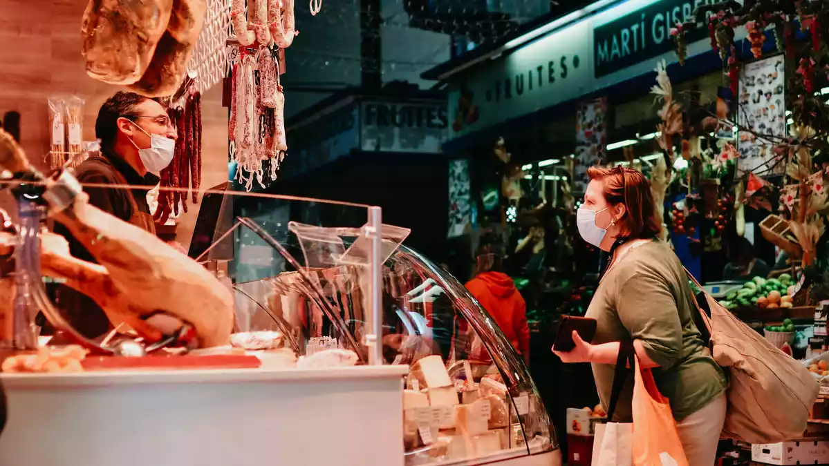 imatge d'una dona comprant a una parada del Mercat Central de Reus