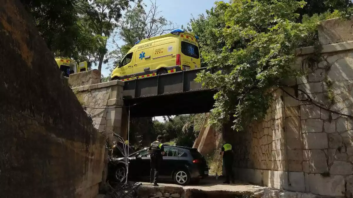 El SEM, Bombers i Policia Local de Cambrils treballant en l'accident d'un cotxe que ha caigut d'un pont