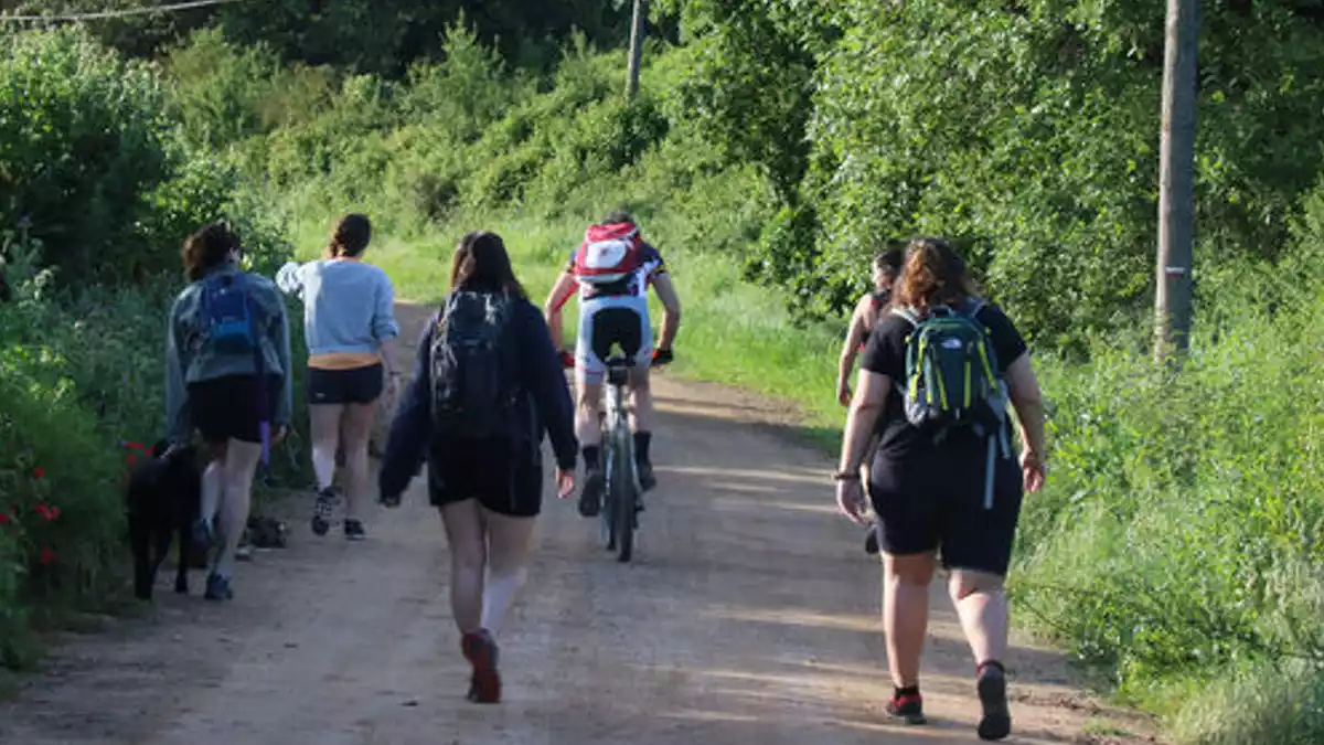 Un ciclista i diversos corredors en un camí rural a l'Empordà